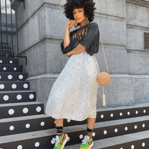 How to style a midi skirt with a t-shirt with balance. Polka dot midi skirt outfit with oversized t-shirt colorful sneakers and bold street style