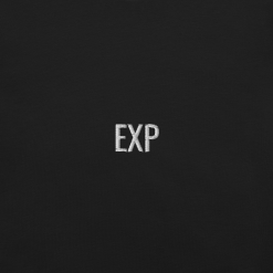 Close-up of embroidered EXP typography on black minimalist t-shirt